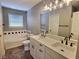Bathroom features a double vanity, soaking tub, and tile flooring at 2062 Sumpter Trl, Columbus, IN 47203