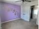 Spacious bedroom featuring a purple wall and double doors at 2062 Sumpter Trl, Columbus, IN 47203