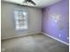 Bright bedroom with purple accent wall and ceiling fan at 2062 Sumpter Trl, Columbus, IN 47203