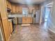 Kitchen with oak cabinets, stainless steel appliances, and tile floor at 2062 Sumpter Trl, Columbus, IN 47203