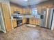 Kitchen with oak cabinets, stainless steel appliances, and tile floor at 2062 Sumpter Trl, Columbus, IN 47203