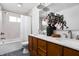 Bright bathroom featuring a double vanity, quartz countertops, a shower over tub, and decorative accents at 2894 W Grove Dr, Greenfield, IN 46140