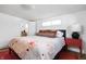 Stylish bedroom featuring a floral bedspread, natural light, and hardwood floors at 2894 W Grove Dr, Greenfield, IN 46140