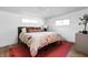 Bright bedroom with hardwood floors, modern decor, and a large floral bedspread at 2894 W Grove Dr, Greenfield, IN 46140