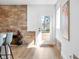 Bright dining area featuring a stone accent wall and a door leading to an outdoor deck at 2894 W Grove Dr, Greenfield, IN 46140