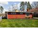 Red home with a well-maintained lawn and neatly trimmed bushes lining the base of the home at 2894 W Grove Dr, Greenfield, IN 46140