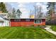 Charming red home exterior with a well-manicured lawn and a neat sidewalk leading to the front at 2894 W Grove Dr, Greenfield, IN 46140