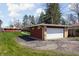 A detached garage with a white door complements the modern home and well-maintained lawn at 2894 W Grove Dr, Greenfield, IN 46140