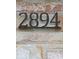 Close-up of the house number '2894' displayed on a textured brick exterior wall at 2894 W Grove Dr, Greenfield, IN 46140