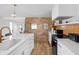 Bright kitchen featuring white cabinets, stone wall accent, and modern appliances at 2894 W Grove Dr, Greenfield, IN 46140