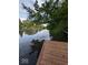 Picturesque lake view with a private wooden dock and serene water reflecting the blue sky at 2894 W Grove Dr, Greenfield, IN 46140
