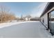 Snowy backyard with a view of a neighboring home and a fenced area at 3249 Cherry Lake Ln, Indianapolis, IN 46235