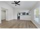 Open concept living room with kitchen view, hardwood floors, and a ceiling fan at 3249 Cherry Lake Ln, Indianapolis, IN 46235