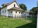 Spacious backyard featuring a well-maintained lawn and bordered by a classic chain-link fence at 325 S Market St, Thorntown, IN 46071