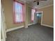 Cozy bedroom with gray carpet and pink curtains at 325 S Market St, Thorntown, IN 46071