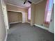 Simple bedroom with gray carpet and built-in shelving at 325 S Market St, Thorntown, IN 46071