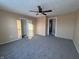 Bright bedroom with ceiling fan, grey carpet, and brick accent wall at 325 S Market St, Thorntown, IN 46071