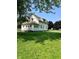 Well-maintained home featuring a spacious, grassy lawn and complemented by mature trees at 325 S Market St, Thorntown, IN 46071