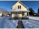 Charming yellow house with snow-covered yard and front porch at 325 S Market St, Thorntown, IN 46071