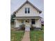 A charming yellow house with a front porch and yard at 325 S Market St, Thorntown, IN 46071