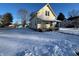 House exterior showcasing a snowy yard and chain link fence at 325 S Market St, Thorntown, IN 46071