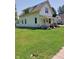 Charming two-story home with a spacious lawn and a quaint front porch, perfect for relaxing at 325 S Market St, Thorntown, IN 46071