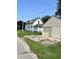 View of home with detached garage, driveway, and spacious yard at 325 S Market St, Thorntown, IN 46071