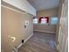 Laundry room with upper cabinets, wood-look flooring, and a window at 325 S Market St, Thorntown, IN 46071