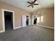 Bright living room with gray carpet, leading to kitchen and stairs at 325 S Market St, Thorntown, IN 46071