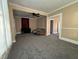 Living room with gray carpeting, a couch, and access to other areas at 325 S Market St, Thorntown, IN 46071