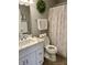 Clean bathroom with white vanity, marble countertop, and patterned shower curtain at 3532 Soaring Eagle Ct, Indianapolis, IN 46214