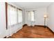 Bright bedroom with hardwood floors and sheer curtains on the windows at 3856 Hoyt Ave, Indianapolis, IN 46203