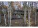 Aerial view of house on wooded lot with lake access at 387 W Roszell Dr, Nineveh, IN 46164
