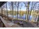 Relaxing backyard with fire pit and steps leading down to the lake at 387 W Roszell Dr, Nineveh, IN 46164