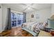 Bedroom with lake view, wood floors, and sliding door to deck at 387 W Roszell Dr, Nineveh, IN 46164