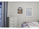 Bedroom with white dresser and lake-themed artwork at 387 W Roszell Dr, Nineveh, IN 46164