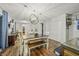 Bright dining room with chandelier and view into living room at 387 W Roszell Dr, Nineveh, IN 46164