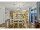 Dining area with chandelier and adjacent kitchen at 387 W Roszell Dr, Nineveh, IN 46164