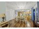 Open concept dining room with chandelier and kitchen views at 387 W Roszell Dr, Nineveh, IN 46164