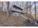 Two-story home with large deck and stairs leading to the lake at 387 W Roszell Dr, Nineveh, IN 46164