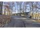 Gray lake house nestled among trees with a long private driveway at 387 W Roszell Dr, Nineveh, IN 46164