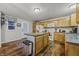 Eat-in kitchen with island, oak cabinets, and vinyl plank flooring at 387 W Roszell Dr, Nineveh, IN 46164