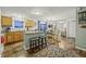 Kitchen with island, wood cabinets, and view into living and dining areas at 387 W Roszell Dr, Nineveh, IN 46164