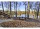 Relaxing lakefront patio with fire pit and seating at 387 W Roszell Dr, Nineveh, IN 46164