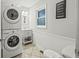 Convenient laundry room with a stacked washer and dryer, and a small vanity at 387 W Roszell Dr, Nineveh, IN 46164