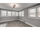 Sunroom with wood-look tile floor and multiple windows at 42 E Brookville Rd, Fountaintown, IN 46130