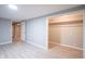 Finished basement with gray walls, wood-look floors, and closet at 4201 Westbourne Dr, Indianapolis, IN 46205