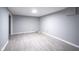 Spacious basement with gray walls and wood-look floors at 4201 Westbourne Dr, Indianapolis, IN 46205