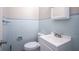 Clean bathroom with light blue tiled walls and vanity at 4201 Westbourne Dr, Indianapolis, IN 46205
