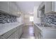 Modern kitchen with grey cabinets and a granite countertop at 4201 Westbourne Dr, Indianapolis, IN 46205
